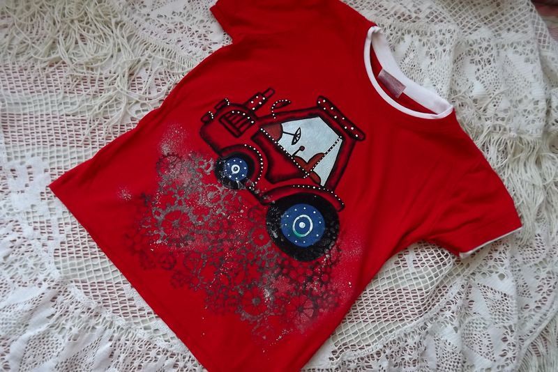 Ručně malovaný traktor s modrými koly na červeném tričku s krátkým rukávem a vrstveným efektem